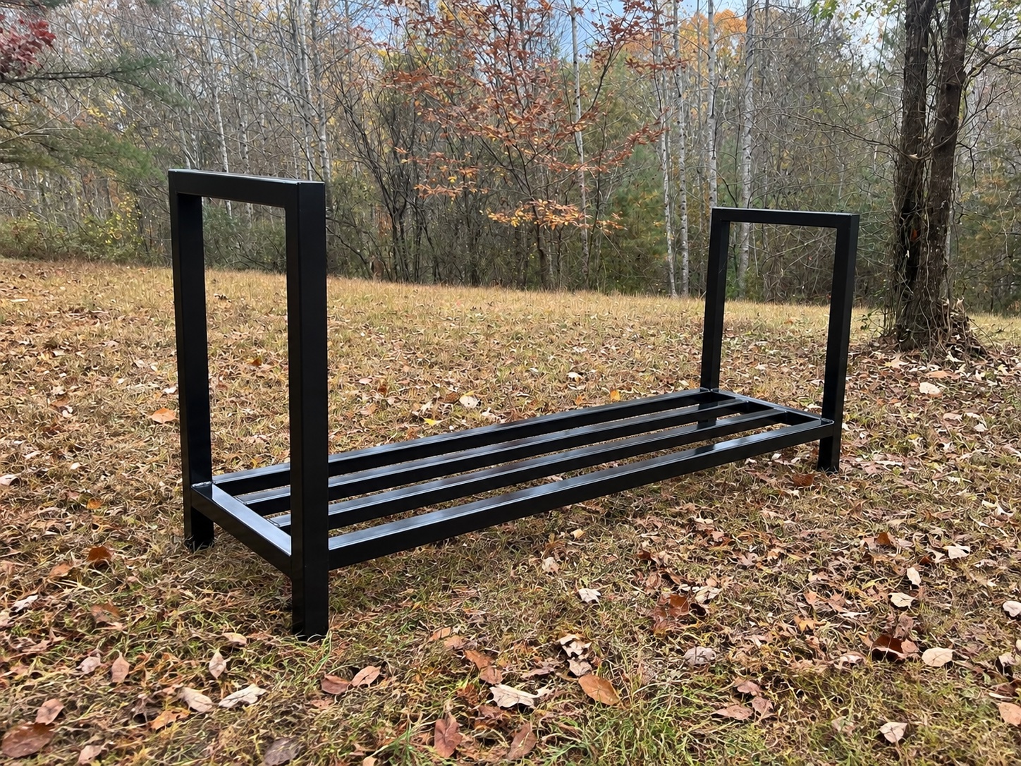 Finished black steel firewood rack fabricated by Valor Outdoor Design & Build